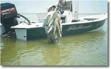 Capt.Tommy Hardegree with a stringer of trout and red's